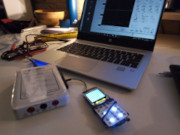 The phone wired up to an oscilloscope